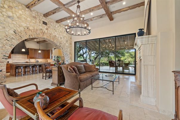 Chandelier, Dining room, Interior, Kitchen, Living room, Pendant Lights, Recessed Lighting, Stainless Steel Appliances, Stone Walls, Wooden Beams