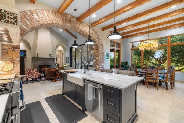 Chandelier, Dining room, Fireplace, Interior, Kitchen, Living room, Pendant Lights, Recessed Lighting, Stainless Steel Appliances, Stone Walls, Wooden Beams