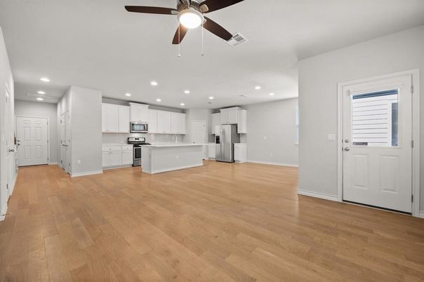 Empty room, Interior, Kitchen, Recessed Lighting, Stainless Steel Appliances, Wood Texture Flooring