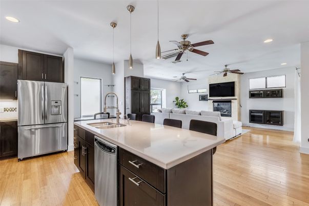 Fireplace, Interior, Kitchen, Living room, Pendant Lights, Recessed Lighting, Stainless Steel Appliances, Wood Texture Flooring
