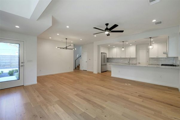 Empty room, Interior, Kitchen, Pendant Lights, Recessed Lighting, Stainless Steel Appliances, Wood Texture Flooring