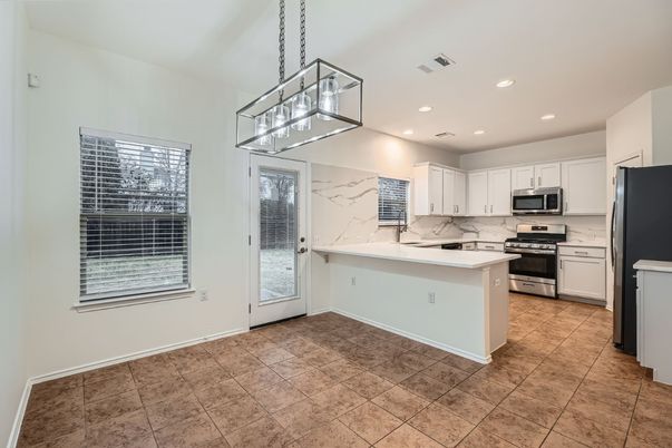 Interior, Kitchen, Marble Walls, Pendant Lights, Recessed Lighting, Stainless Steel Appliances