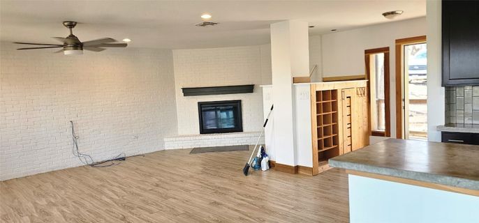Empty room, Fireplace, Interior, Recessed Lighting, Stone Walls, Wood Texture Flooring