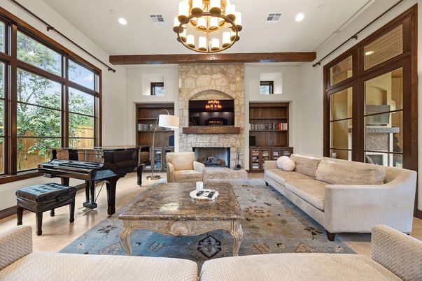 Chandelier, Fireplace, Interior, Living room, Piano, Recessed Lighting, Stone Walls, Wood Texture Flooring
