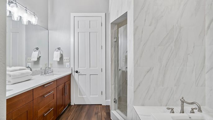 Bathroom, Dual Sink Vanities, Glass Shower, Interior, Marble Walls, Wood Texture Flooring