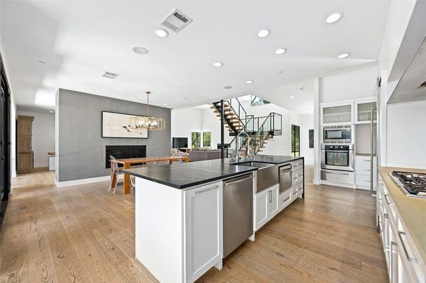 Dining room, Fireplace, Interior, Kitchen, Pendant Lights, Recessed Lighting, Stainless Steel Appliances, Wood Texture Flooring