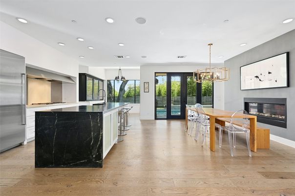 Chandelier, Dining room, Fireplace, Interior, Kitchen, Pendant Lights, Recessed Lighting, Stainless Steel Appliances, Wood Texture Flooring
