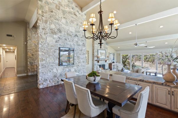 Chandelier, Dining room, Fireplace, Interior, Recessed Lighting, Stone Walls, Wood Texture Flooring