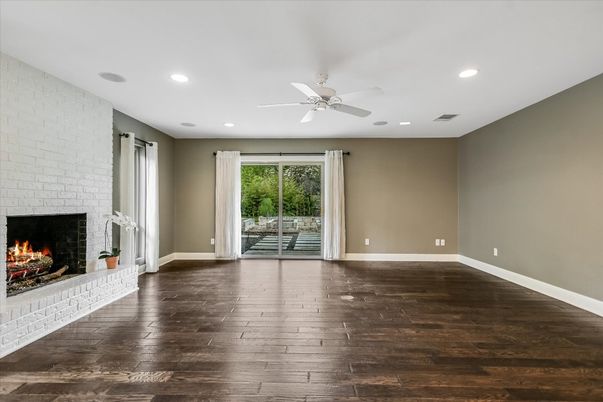Empty room, Fireplace, Interior, Recessed Lighting, Stone Walls, Wood Texture Flooring