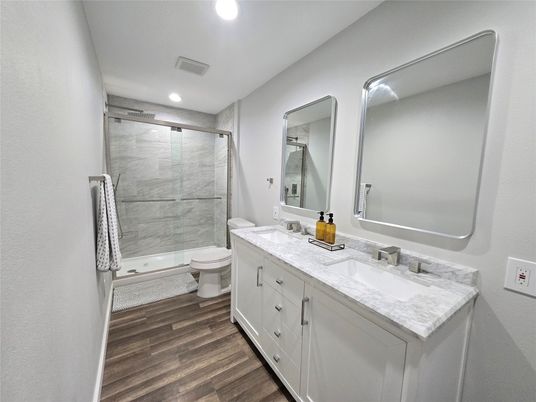 Bathroom, Dual Sink Vanities, Glass Shower, Interior, Recessed Lighting, Wood Texture Flooring