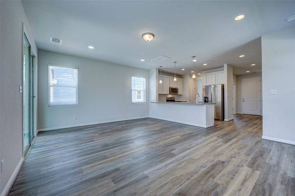 Empty room, Interior, Kitchen, Pendant Lights, Recessed Lighting, Stainless Steel Appliances, Wood Texture Flooring