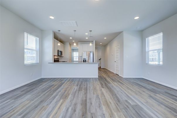 Empty room, Interior, Kitchen, Pendant Lights, Recessed Lighting, Stainless Steel Appliances, Wood Texture Flooring