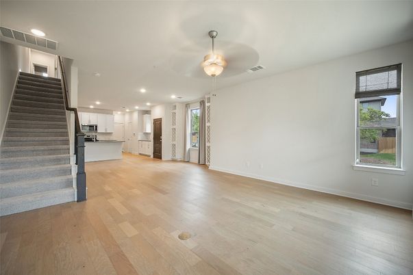 Empty room, Interior, Kitchen, Recessed Lighting, Stainless Steel Appliances, Wood Texture Flooring