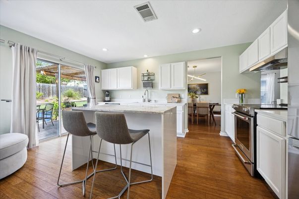 Dining room, Interior, Kitchen, Pendant Lights, Recessed Lighting, Stainless Steel Appliances, Wood Texture Flooring
