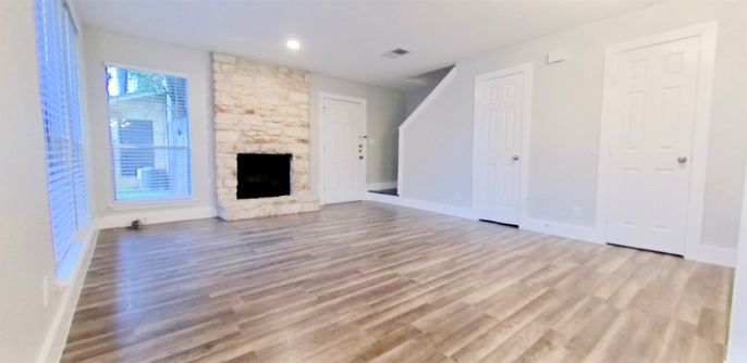 Empty room, Fireplace, Interior, Recessed Lighting, Stone Walls, Wood Texture Flooring