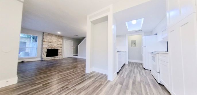 Empty room, Fireplace, Interior, Recessed Lighting, Stone Walls, Washer, Wood Texture Flooring