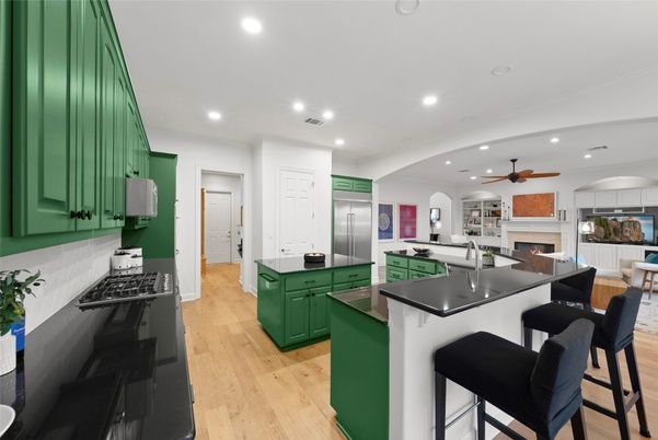 Dining room, Fireplace, Interior, Kitchen, Recessed Lighting, Stainless Steel Appliances, Wood Texture Flooring