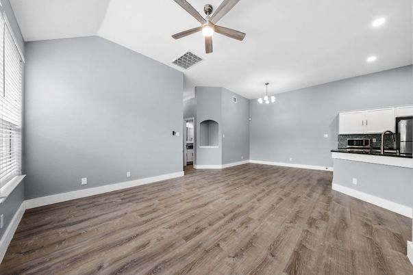 Empty room, Interior, Kitchen, Pendant Lights, Recessed Lighting, Stainless Steel Appliances, Wood Texture Flooring