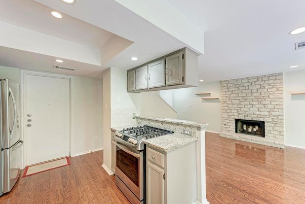 Fireplace, Interior, Kitchen, Recessed Lighting, Stainless Steel Appliances, Stone Walls, Wood Texture Flooring