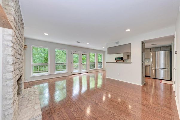 Empty room, Interior, Kitchen, Recessed Lighting, Stainless Steel Appliances, Stone Walls, Wood Texture Flooring