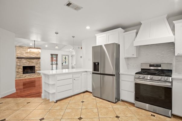 Fireplace, Interior, Kitchen, Pendant Lights, Recessed Lighting, Stainless Steel Appliances, Stone Walls, Wood Texture Flooring