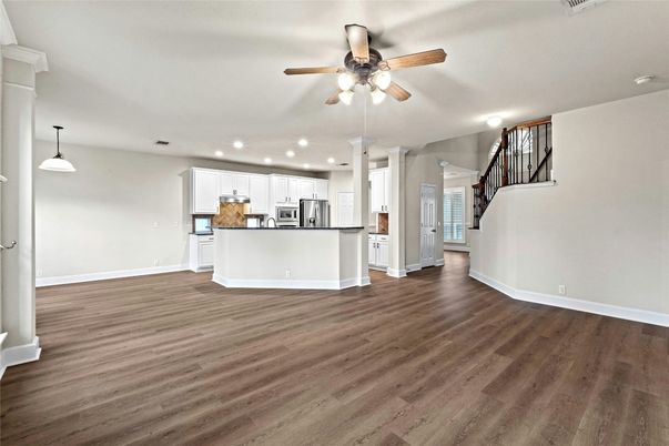 Empty room, Interior, Kitchen, Pendant Lights, Recessed Lighting, Stainless Steel Appliances, Wood Texture Flooring