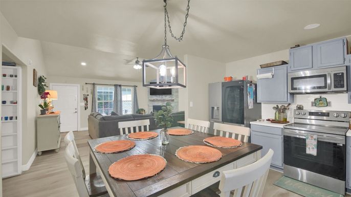 Dining room, Fireplace, Interior, Kitchen, Pendant Lights, Recessed Lighting, Stainless Steel Appliances, Wood Texture Flooring