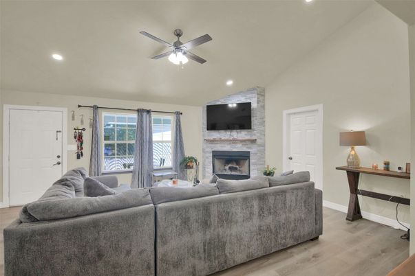 Fireplace, Interior, Living room, Recessed Lighting, Stone Walls, Wood Texture Flooring