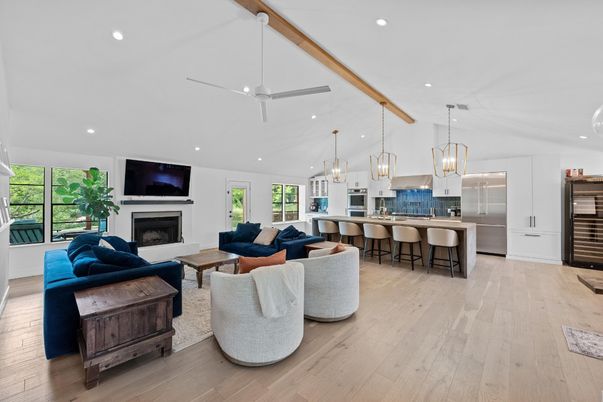 Chandelier, Fireplace, Interior, Kitchen, Living room, Pendant Lights, Recessed Lighting, Stainless Steel Appliances, Wooden Beams, Wood Texture Flooring