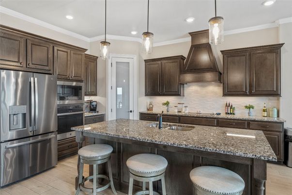 Dining room, Fireplace, Interior, Kitchen, Pendant Lights, Recessed Lighting, Stainless Steel Appliances, Stone Walls, Wood Texture Flooring
