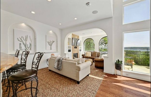 Dining room, Fireplace, Interior, Living room, Recessed Lighting, Water, Wood Texture Flooring
