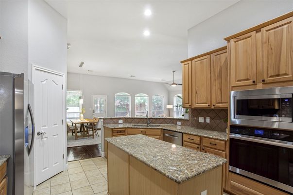 Dining room, Interior, Kitchen, Pendant Lights, Recessed Lighting, Stainless Steel Appliances, Wood Texture Flooring