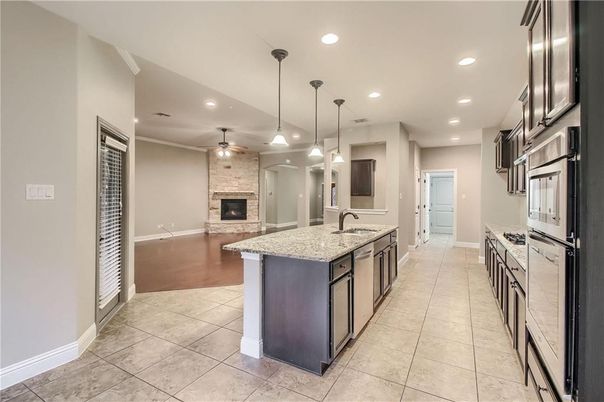 Fireplace, Interior, Kitchen, Pendant Lights, Recessed Lighting, Stainless Steel Appliances, Stone Walls