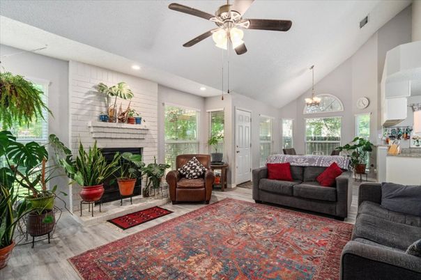 Chandelier, Fireplace, Interior, Living room, Recessed Lighting, Stone Walls, Wood Texture Flooring