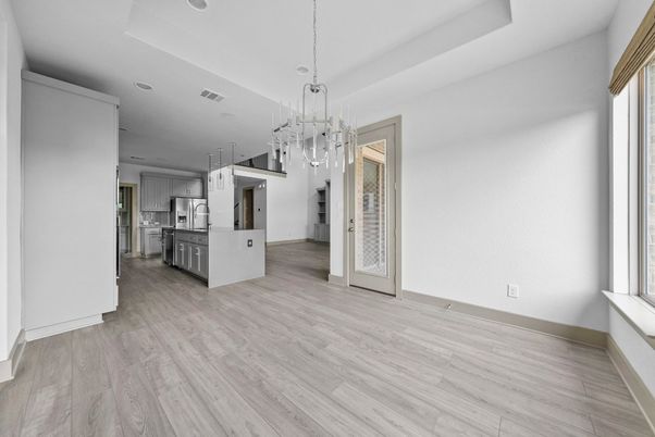 Empty room, Interior, Kitchen, Pendant Lights, Recessed Lighting, Stainless Steel Appliances, Wood Texture Flooring