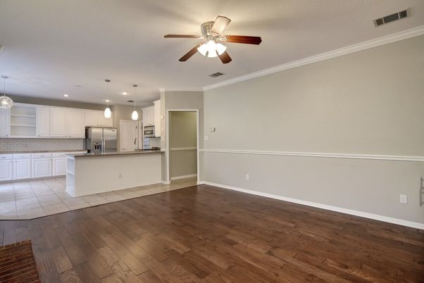Empty room, Interior, Kitchen, Pendant Lights, Recessed Lighting, Stainless Steel Appliances, Wood Texture Flooring