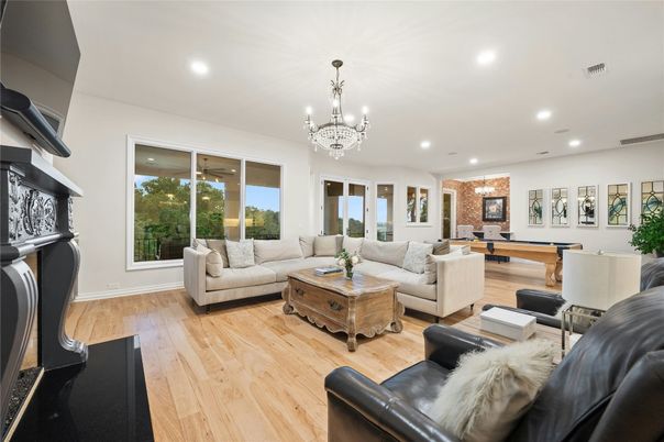 Billiard Table, Chandelier, Fireplace, Game Room, Interior, Living room, Recessed Lighting, Wood Texture Flooring
