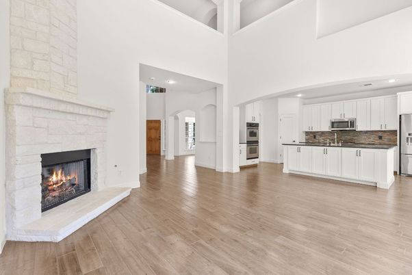 Fireplace, Interior, Kitchen, Recessed Lighting, Stainless Steel Appliances, Stone Walls, Wood Texture Flooring