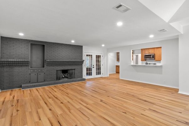 Empty room, Fireplace, Interior, Kitchen, Recessed Lighting, Stone Walls, Wood Texture Flooring