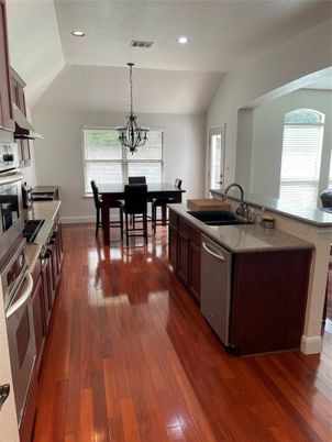 Chandelier, Dining room, Interior, Kitchen, Pendant Lights, Recessed Lighting, Stainless Steel Appliances, Wood Texture Flooring