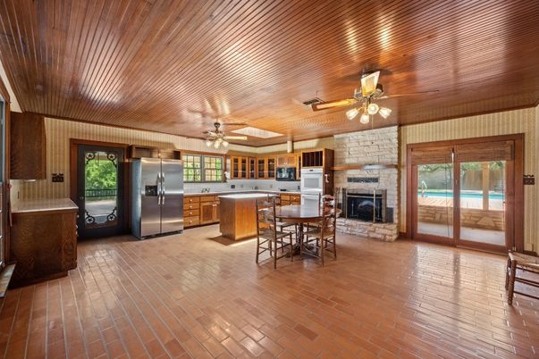 Dining room, Fireplace, Interior, Kitchen, Stainless Steel Appliances, Stone Walls, Wooden Ceilings