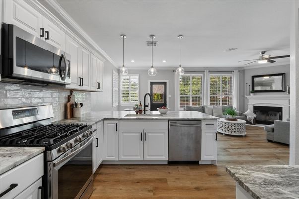 Fireplace, Interior, Kitchen, Living room, Pendant Lights, Recessed Lighting, Stainless Steel Appliances, Wood Texture Flooring