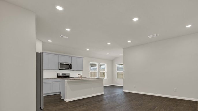 Empty room, Interior, Kitchen, Recessed Lighting, Stainless Steel Appliances, Wood Texture Flooring