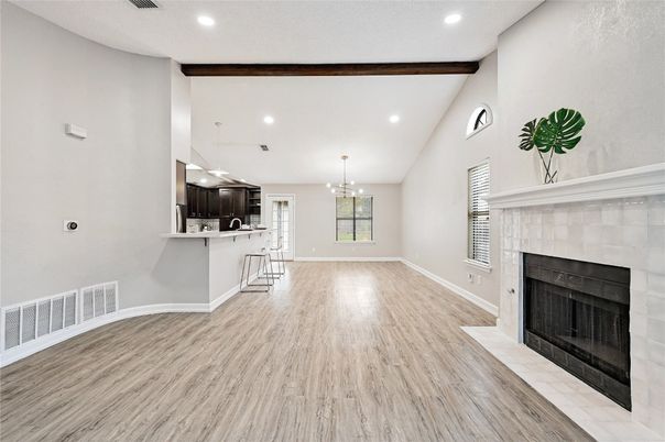 Chandelier, Empty room, Fireplace, Interior, Kitchen, Pendant Lights, Recessed Lighting, Wooden Beams, Wood Texture Flooring
