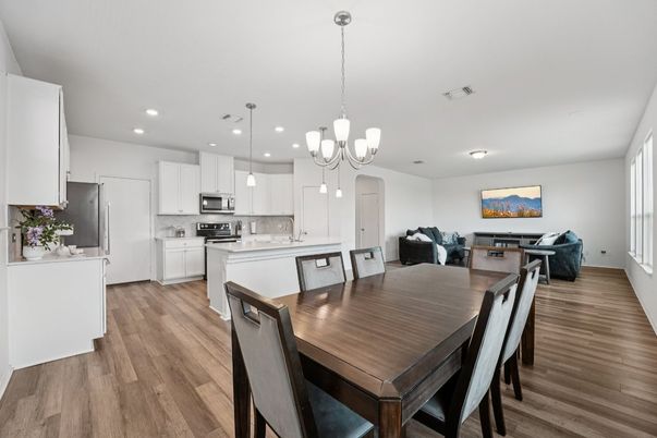 Chandelier, Dining room, Interior, Kitchen, Living room, Pendant Lights, Recessed Lighting, Stainless Steel Appliances, Wood Texture Flooring