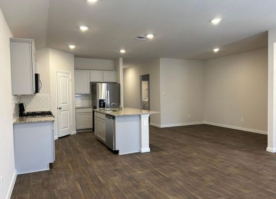 Empty room, Interior, Kitchen, Recessed Lighting, Stainless Steel Appliances, Wood Texture Flooring