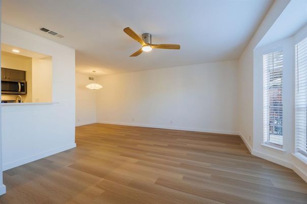Empty room, Interior, Kitchen, Pendant Lights, Recessed Lighting, Stainless Steel Appliances, Wood Texture Flooring