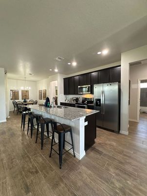Dining room, Interior, Kitchen, Pendant Lights, Recessed Lighting, Stainless Steel Appliances, Wood Texture Flooring