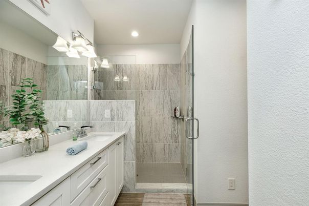 Bathroom, Dual Sink Vanities, Glass Shower, Interior, Marble Walls, Recessed Lighting, Wood Texture Flooring
