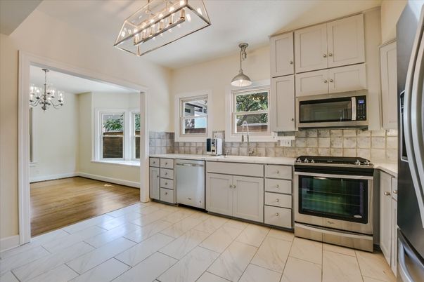 Chandelier, Interior, Kitchen, Marble, Pendant Lights, Stainless Steel Appliances, Wood Texture Flooring